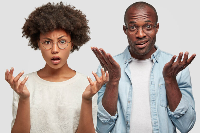 Verbaasde man en vrouw met handgebaren